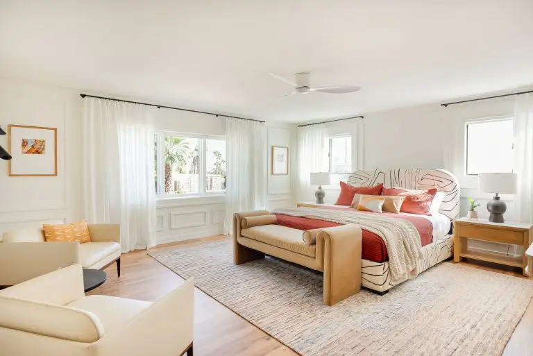 Modern primary suite with neutral palette, coral accents, and custom millwork at Biskra House in Rancho Mirage, California.
