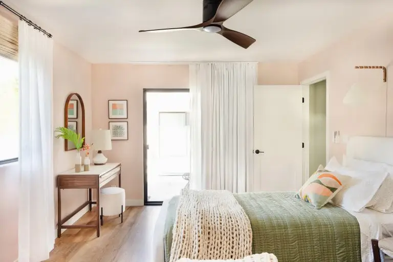 Stylish twin bedroom with layered bedding, playful art, and mid-century accents at Biskra House in Palm Springs area.